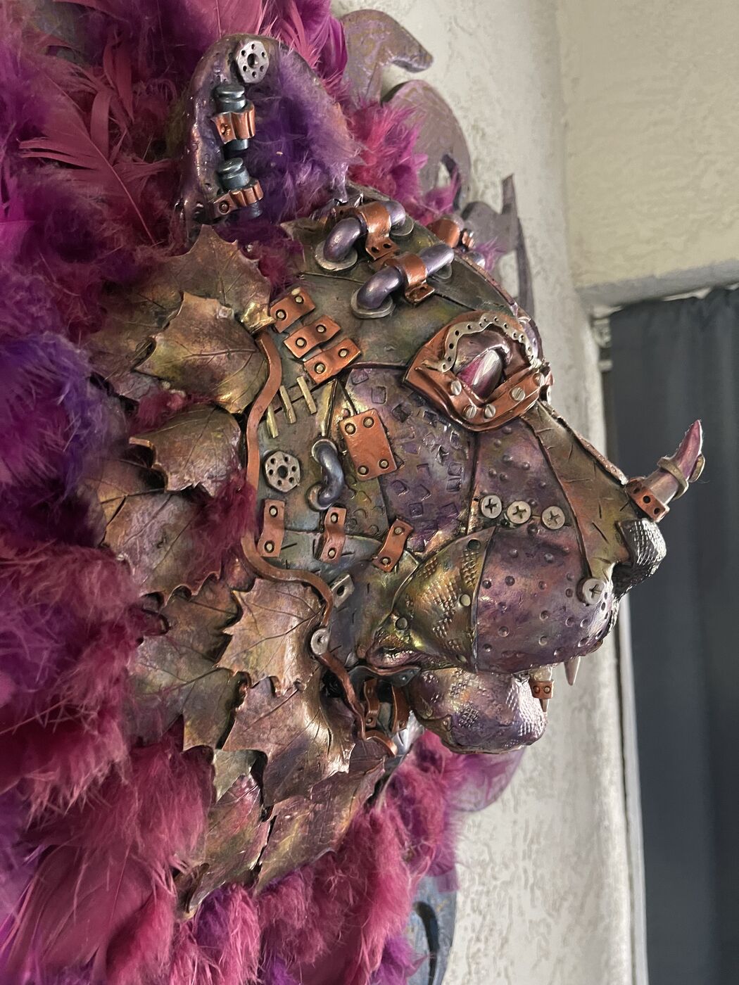 Sculpted steampunk animal-head wall mask by XZanthia — gears, metallic patina and a feather mane (piece 5 of 24)