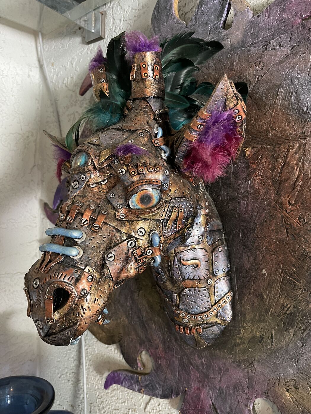 Sculpted steampunk animal-head wall mask by XZanthia — gears, metallic patina and a feather mane (piece 6 of 24)