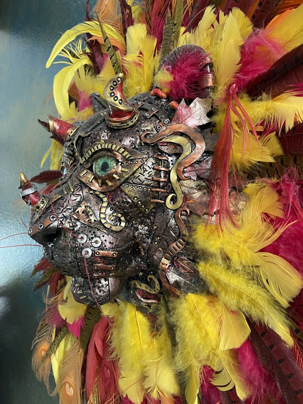 Steampunk lion wall mask by XZanthia with a magenta and yellow feather mane