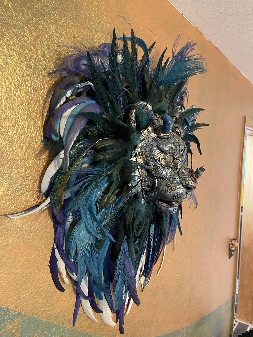 Sculpted steampunk animal-head wall mask by XZanthia — gears, metallic patina and a feather mane (piece 8 of 24)
