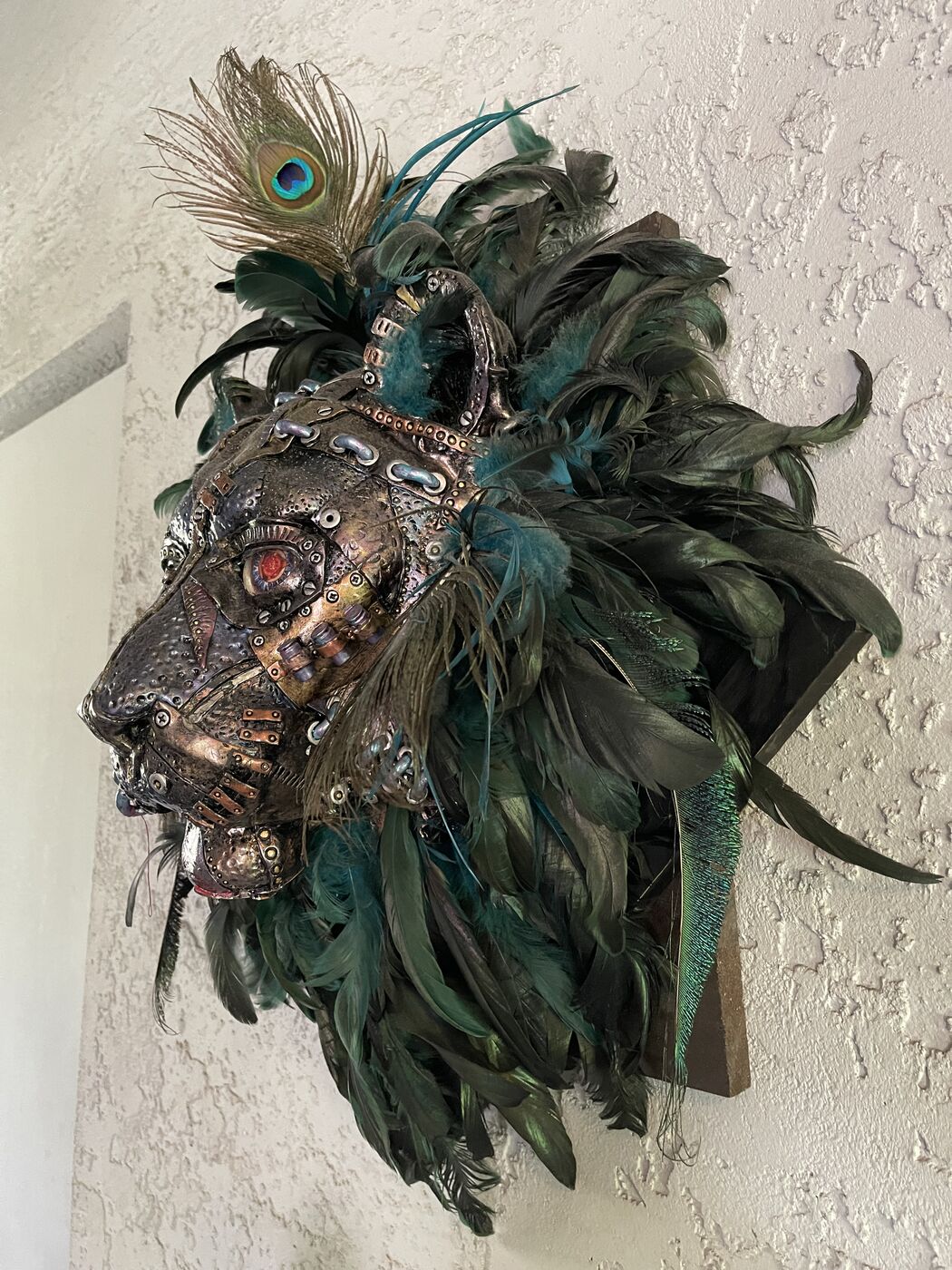 Sculpted steampunk animal-head wall mask by XZanthia — gears, metallic patina and a feather mane (piece 10 of 24)