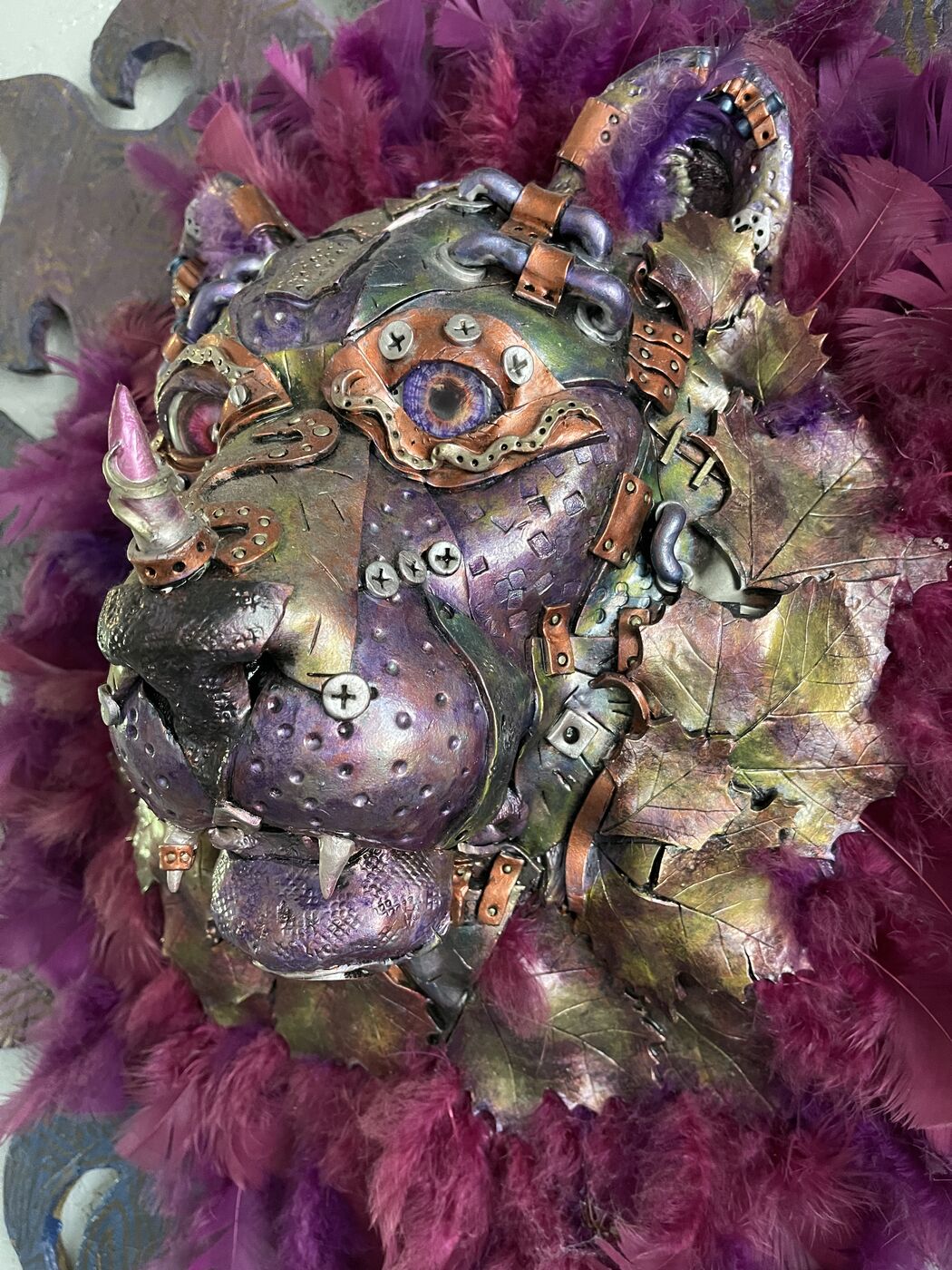 Sculpted steampunk animal-head wall mask by XZanthia — gears, metallic patina and a feather mane (piece 12 of 24)