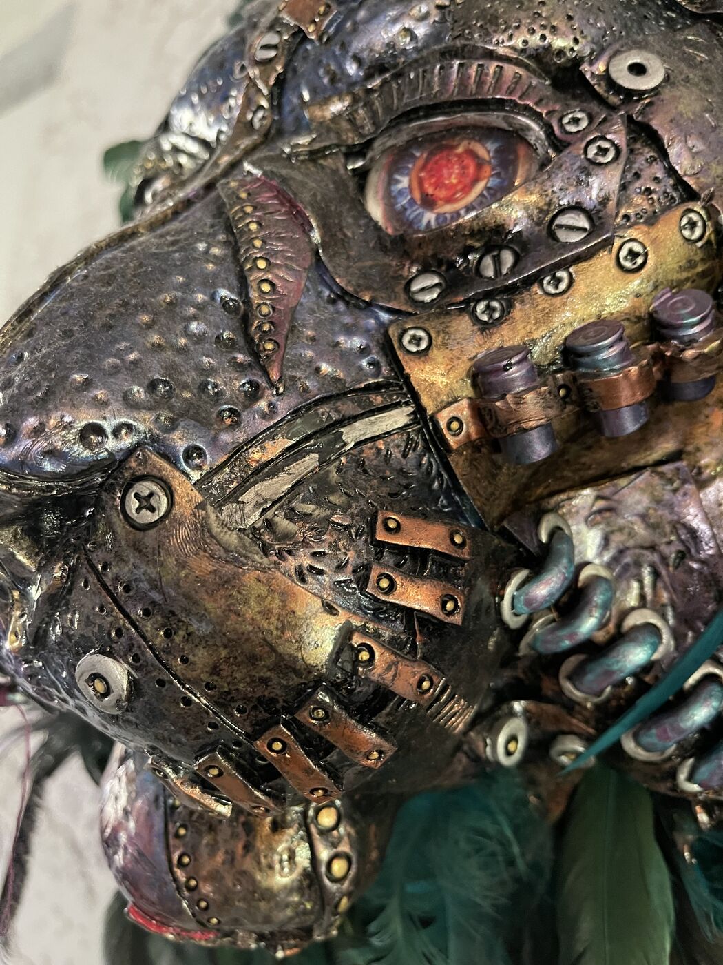 Sculpted steampunk animal-head wall mask by XZanthia — gears, metallic patina and a feather mane (piece 13 of 24)