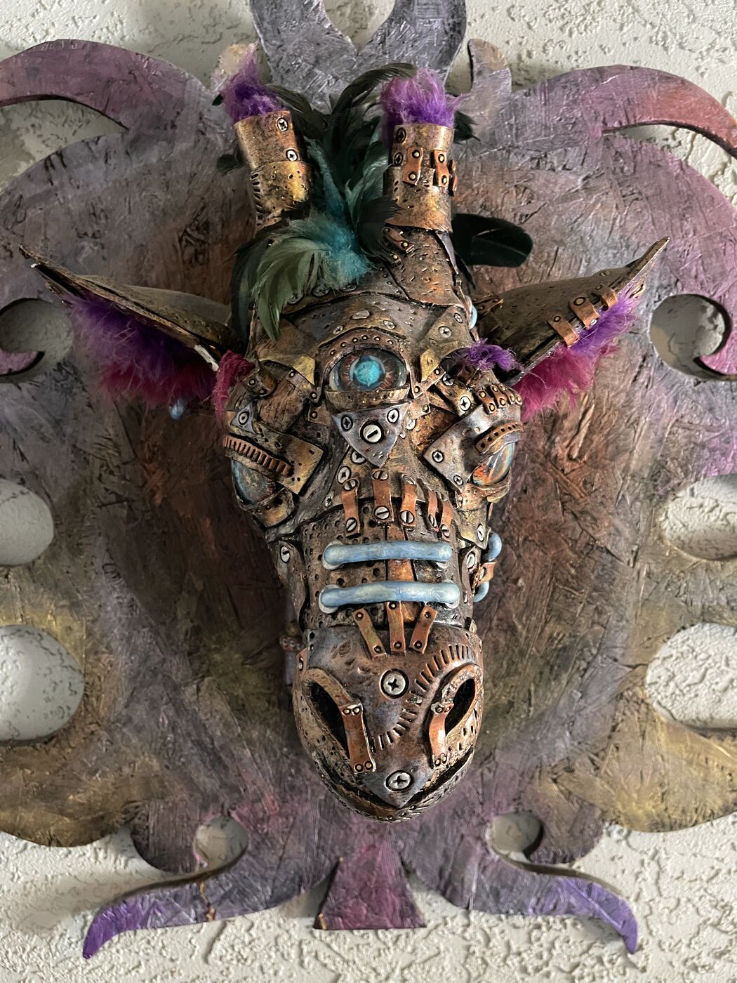 Sculpted steampunk animal-head wall mask by XZanthia — gears, metallic patina and a feather mane (piece 16 of 24)