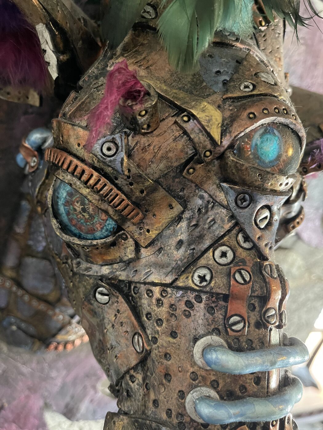 Sculpted steampunk animal-head wall mask by XZanthia — gears, metallic patina and a feather mane (piece 18 of 24)