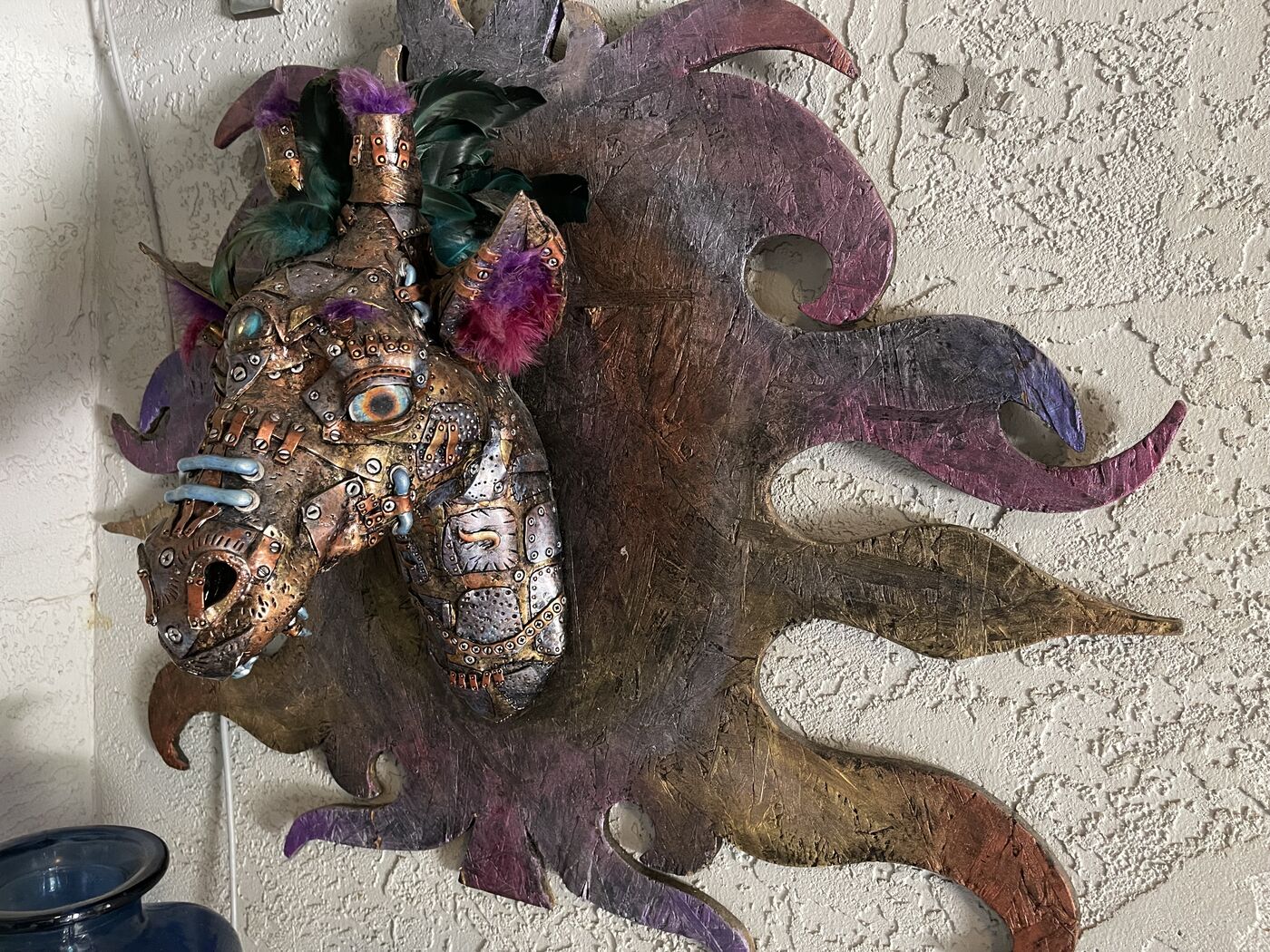 Sculpted steampunk animal-head wall mask by XZanthia — gears, metallic patina and a feather mane (piece 19 of 24)