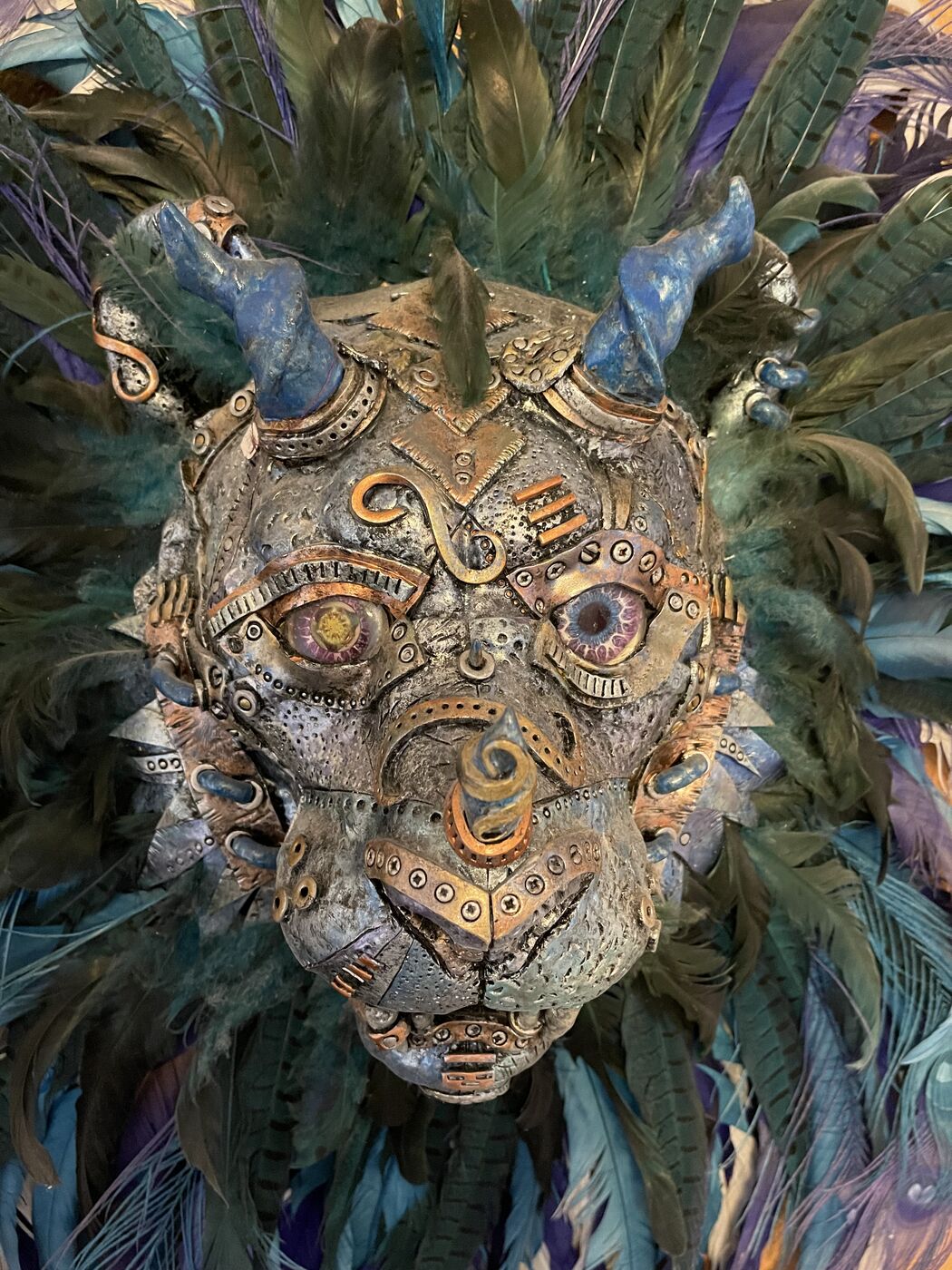 Sculpted steampunk animal-head wall mask by XZanthia — gears, metallic patina and a feather mane (piece 20 of 24)