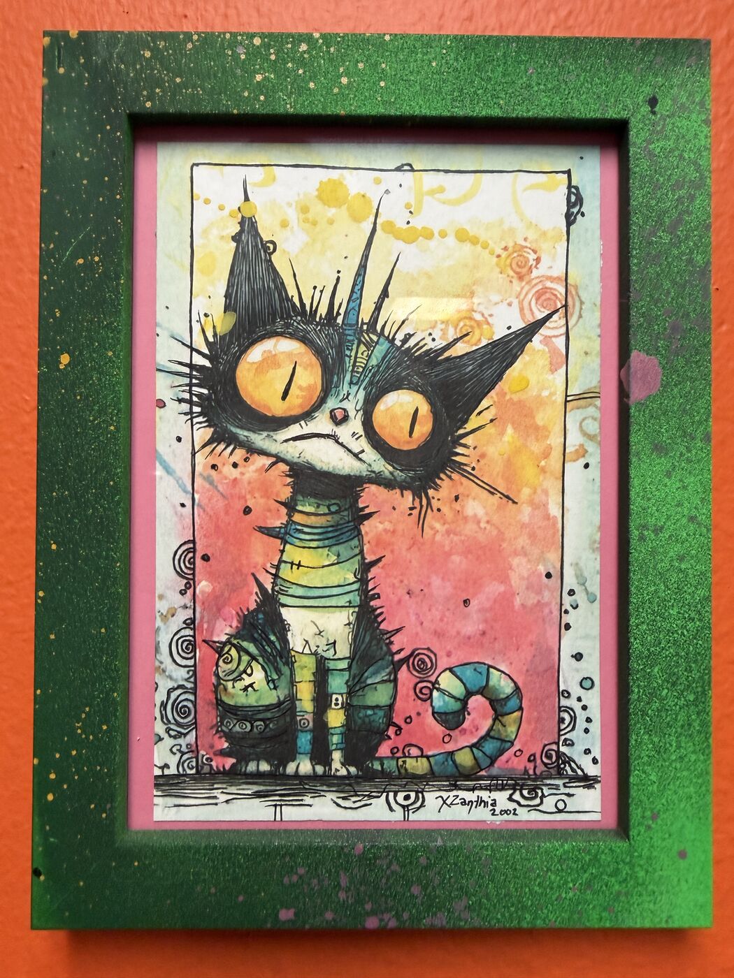 Framed creepy-cute watercolor creature by XZanthia, photographed against her painted gallery wall (piece 1 of 24)