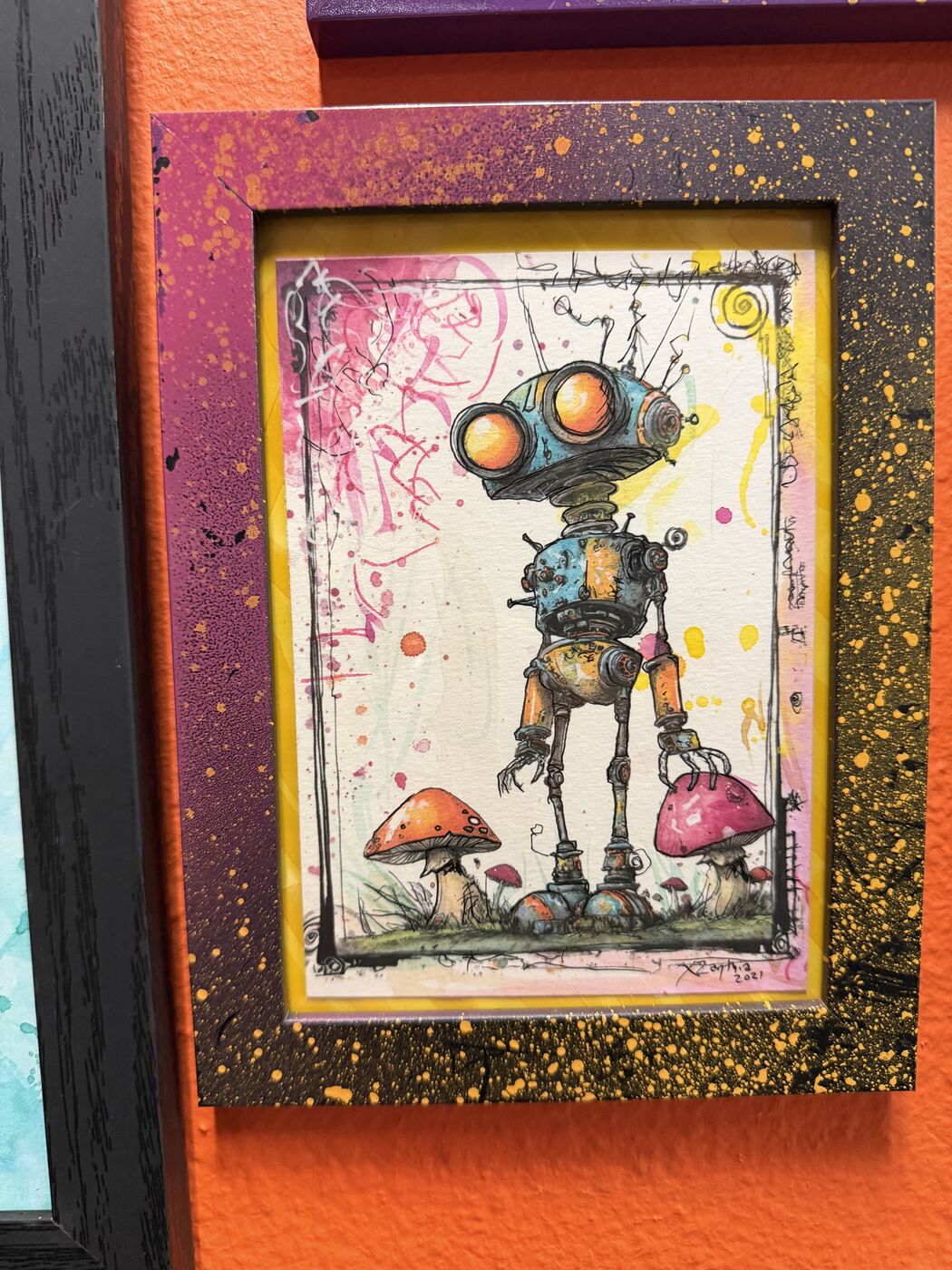 Framed creepy-cute watercolor creature by XZanthia, photographed against her painted gallery wall (piece 2 of 24)