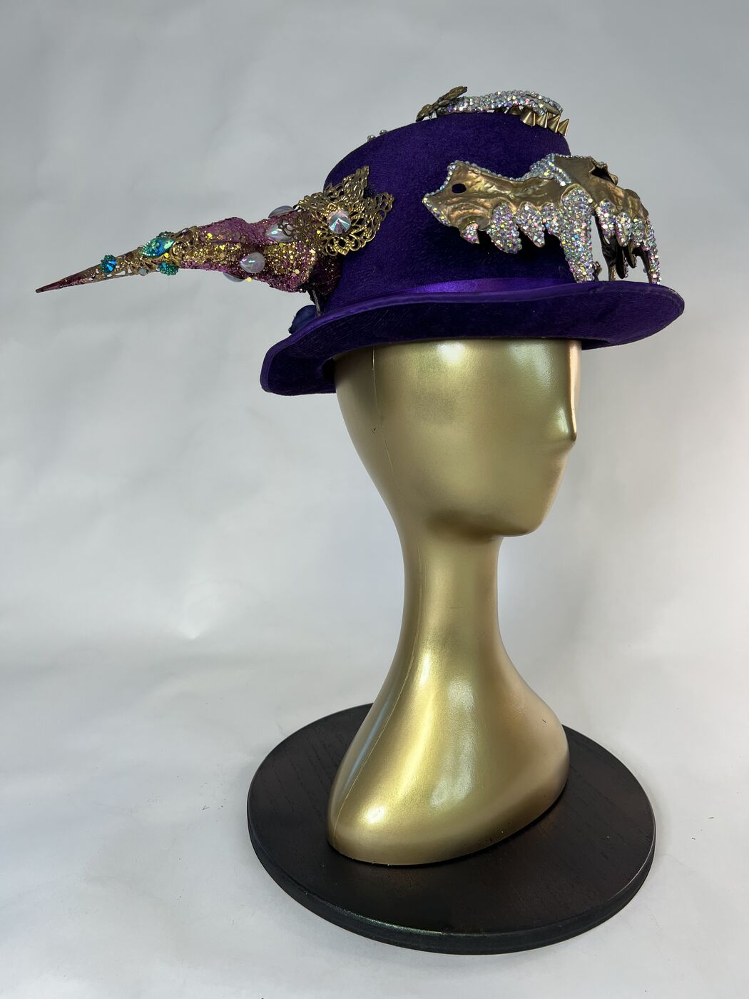 Handmade embellished top hat headpiece by XZanthia with horns and spikes, on a gold mannequin head (piece 1 of 15)