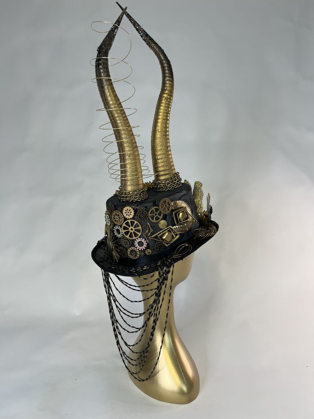 Handmade embellished top hat headpiece by XZanthia with horns and spikes, on a gold mannequin head (piece 2 of 15)