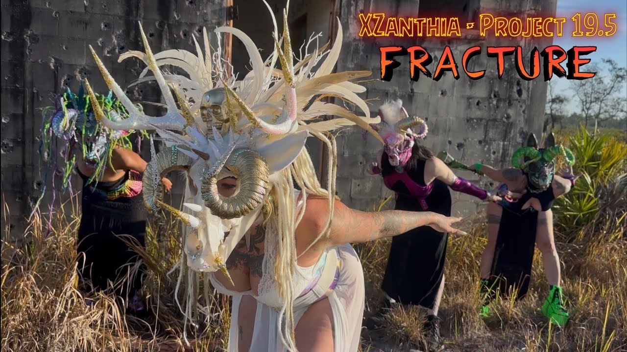 Masked performers in Florida scrubland from the Project 19.5 video 'Fracture'