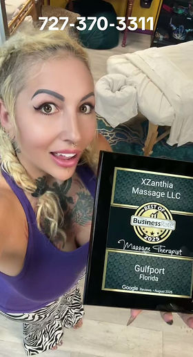 XZanthia holding her XZanthia Massage LLC plaque